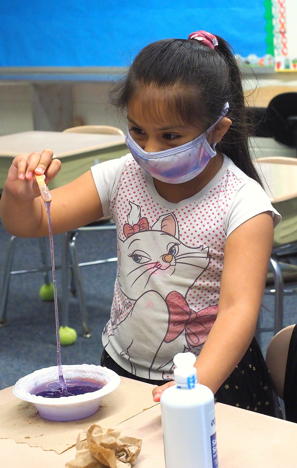 Cristina Mateo Varillas enjoys her newly mixed slime last Wednesday inside Siler City Elementary School. She was one of more than 40 students to attend SCE's Dual Language summer camp last week.